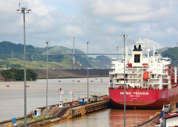 a large red and white boat docked at a dock