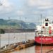 a large red and white boat docked at a dock