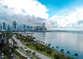 a large body of water with a city in the background