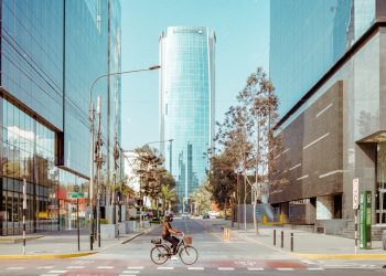 man in black jacket riding bicycle on road during daytime