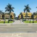 people walking on sidewalk near palm trees during daytime